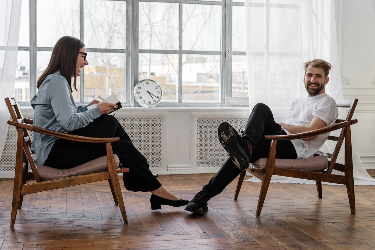 about-img Counselor and client in a positive therapy session in a well-lit room.